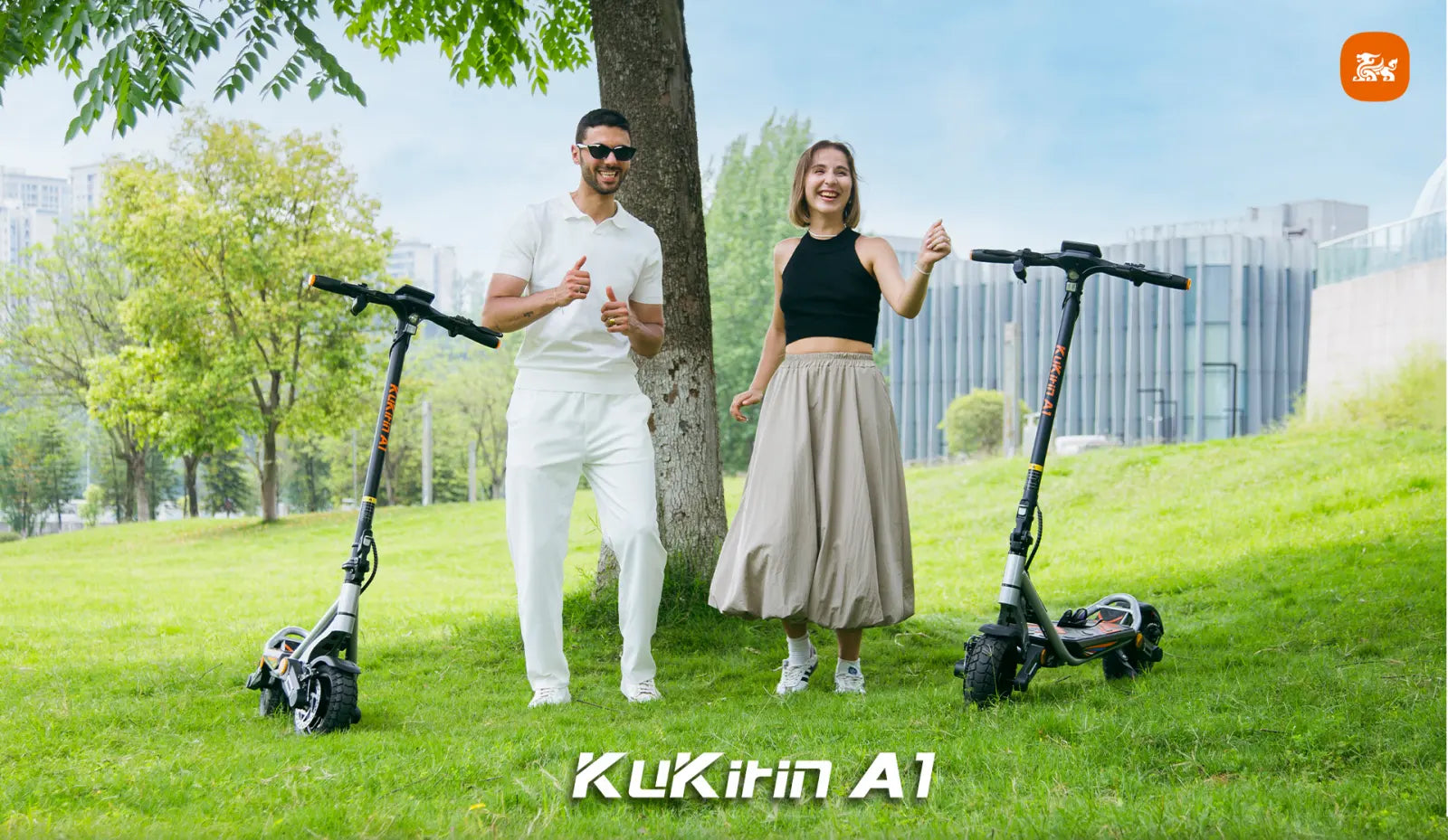 Dual riders enjoying outdoor commuting on the KuKirin A1 electric scooter in a scenic urban park.