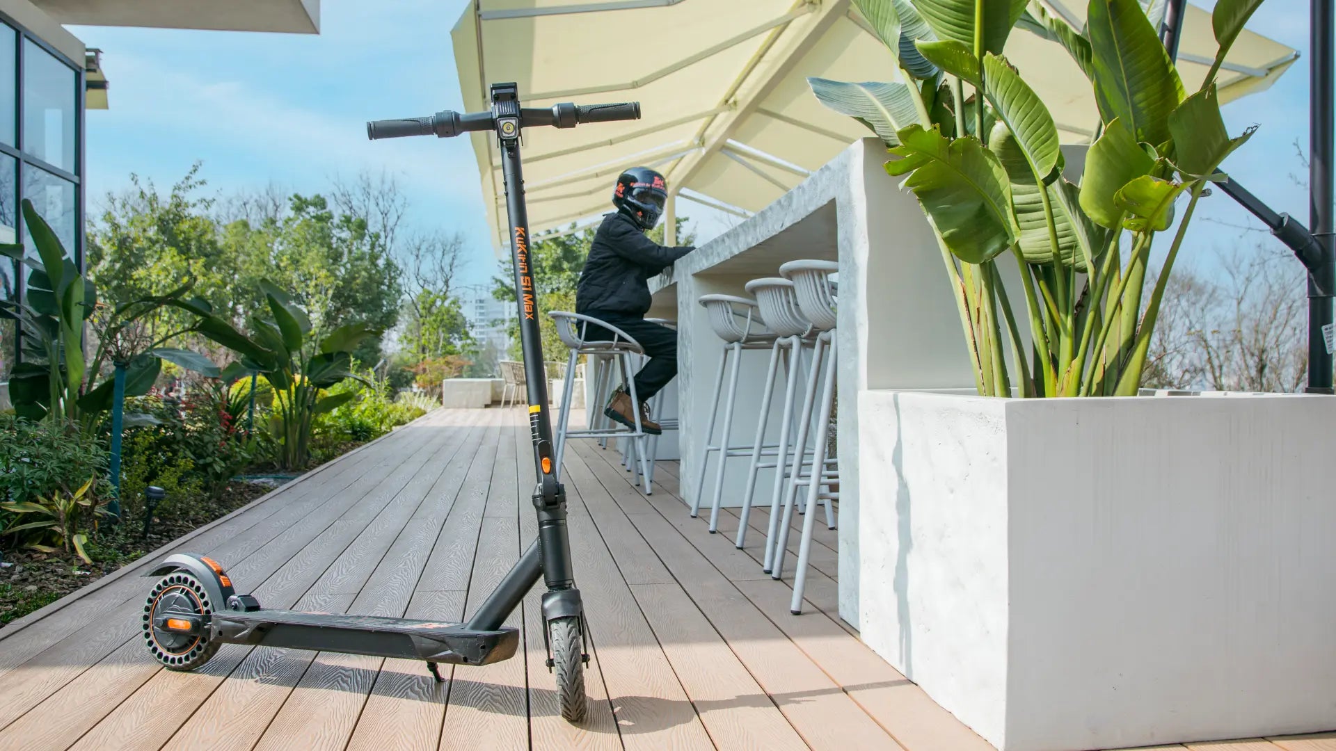 KuKirin S1 Max electric scooter 39km range and 350W motor parked on a city terrace, designed for urban commuting and lightweight travel.